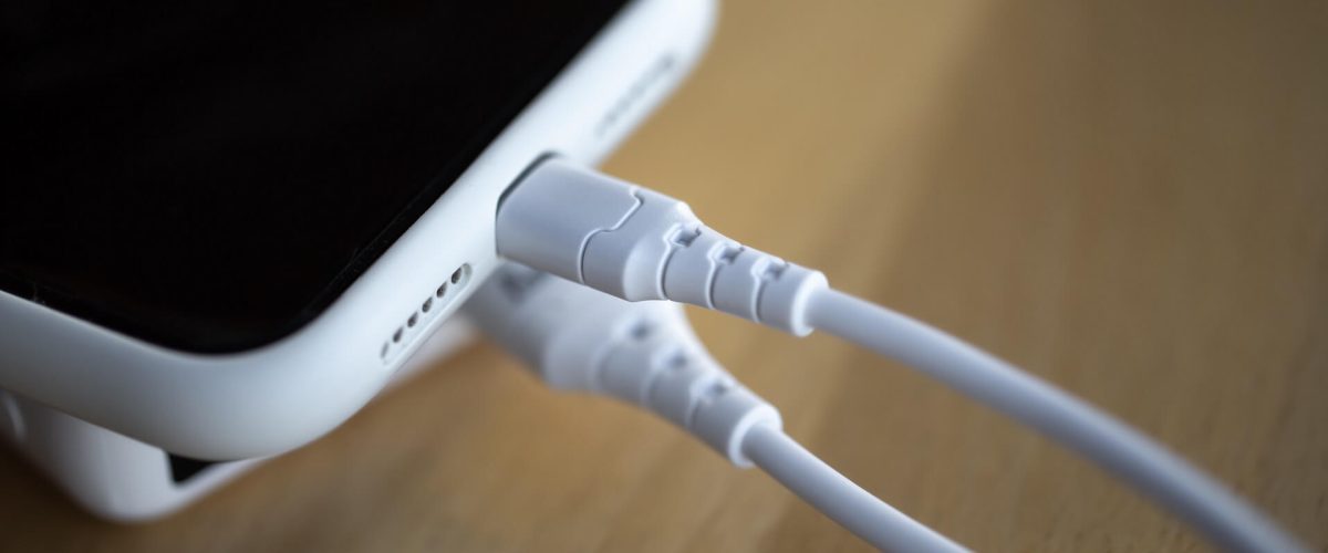 a-smartphone-is-charged-from-a-small-white-power-b-2021-12-09-20-21-28-utc